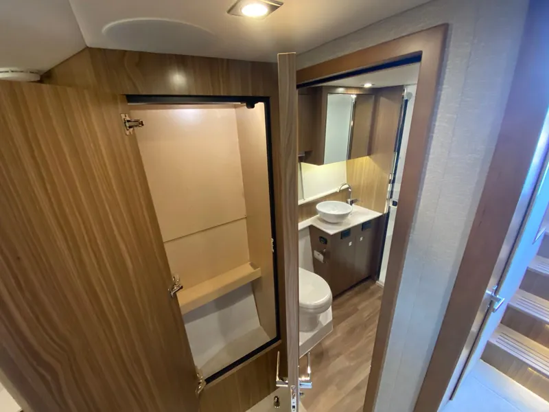 Slide: The Image of Luxurious bathroom interior of 2025 Cruisers Yachts 46 Cantius with modern fixtures and wood accents. - 47
