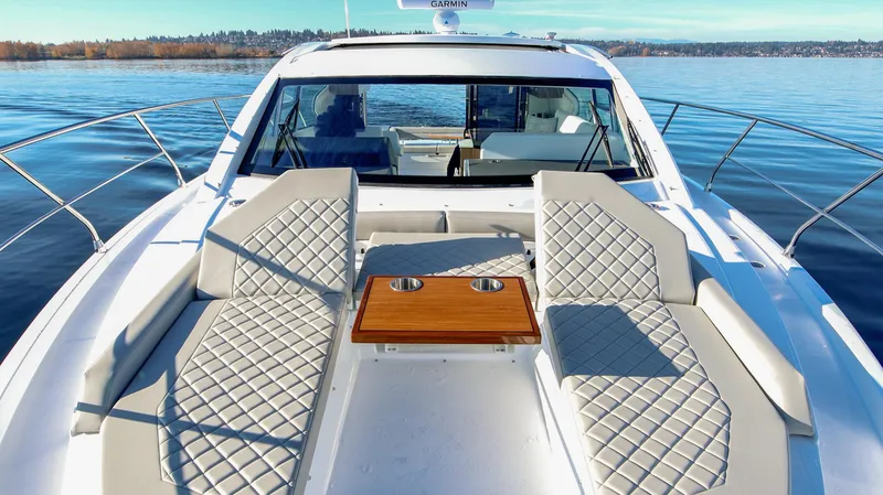 Slide: The Image of Luxurious 2025 Cruisers Yachts 46 Cantius with elegant seating and scenic water view. - 12