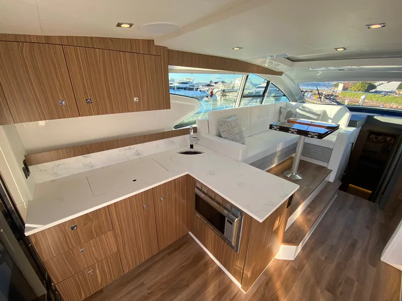 Slide: The Image of Luxurious interior of 2025 Cruisers Yachts 46 Cantius with modern kitchen and seating area. - 23