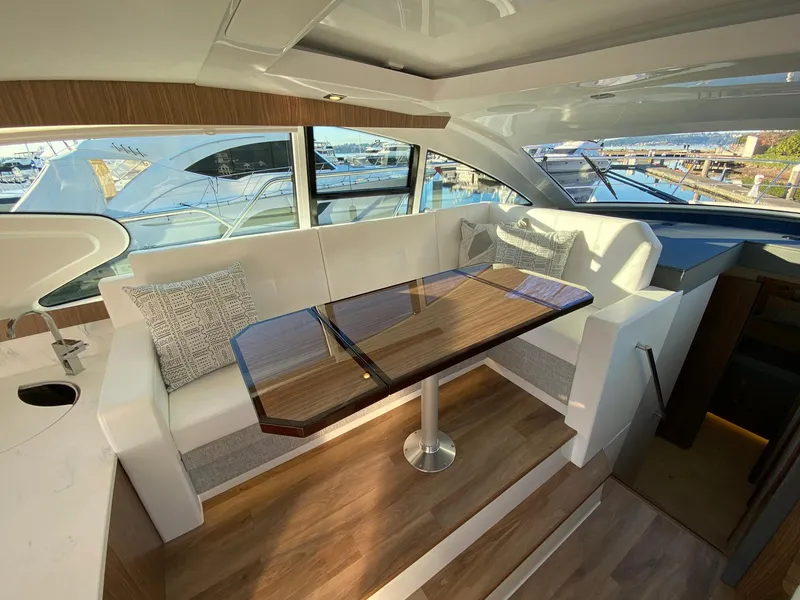 Slide: The Image of Luxurious interior of 2025 Cruisers Yachts 46 Cantius with elegant seating and table. - 28
