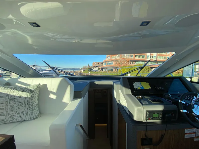 Slide: The Image of Interior view of 2025 Cruisers Yachts 46 Cantius helm with modern dashboard and seating. - 34