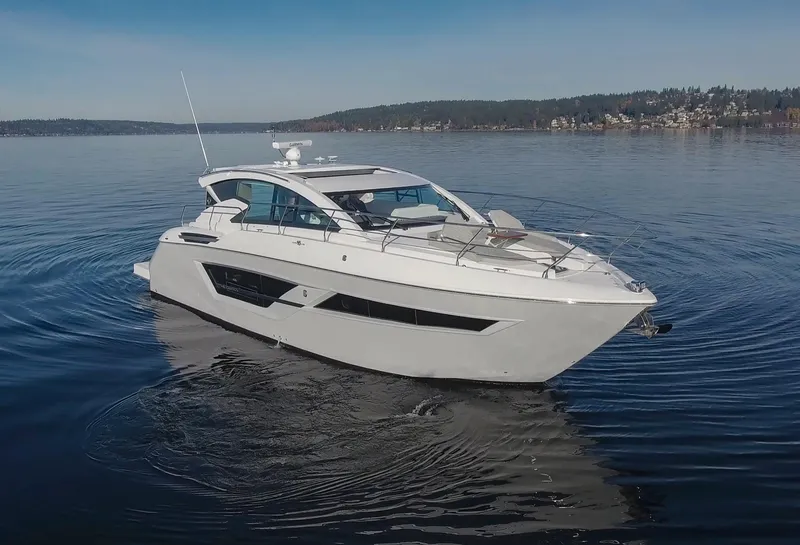 Slide: The Image of 2025 Cruisers Yachts 46 Cantius on serene lake waters. - 4