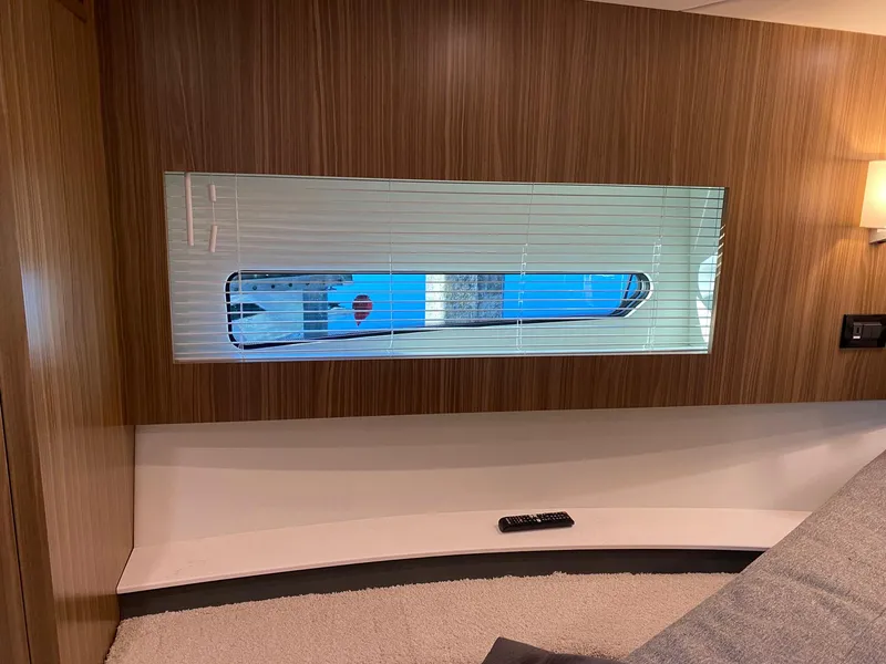 Slide: The Image of Interior view of 2025 Cruisers Yachts 46 Cantius with window and wooden paneling. - 42