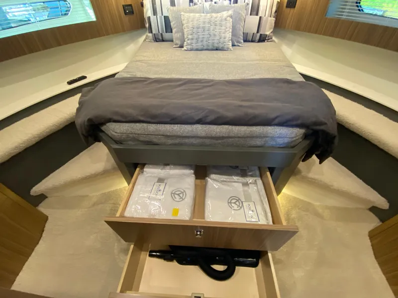 Slide: The Image of Luxurious 2025 Cruisers Yachts 46 Cantius bedroom with storage drawers and elegant bedding. - 45