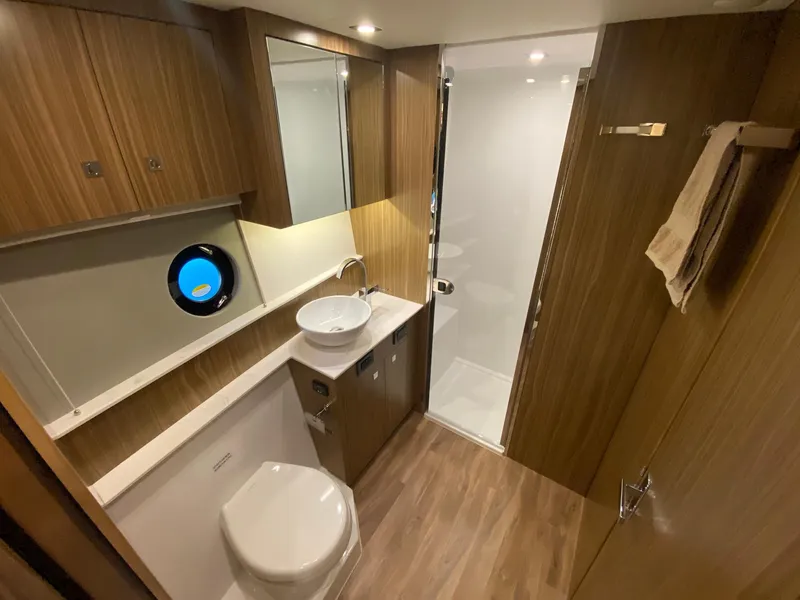 Slide: The Image of Luxurious bathroom in 2025 Cruisers Yachts 46 Cantius with modern fixtures and wood accents. - 48