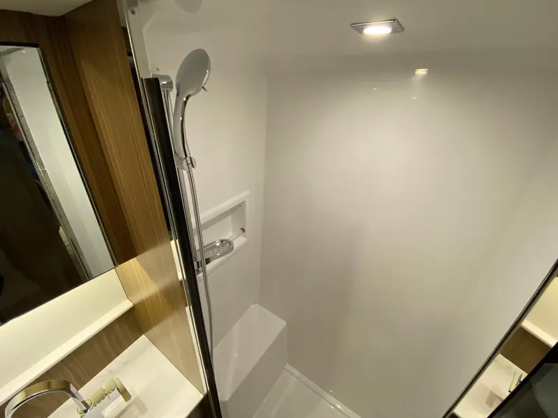 Slide: The Image of Modern shower in 2025 Cruisers Yachts 46 Cantius, featuring sleek design and bright lighting. - 49