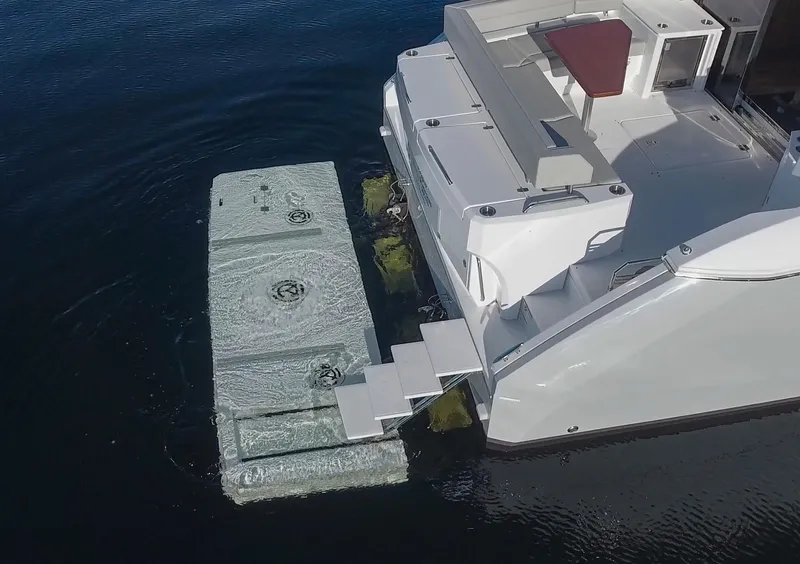 Slide: The Image of 2025 Cruisers Yachts 46 Cantius with hydraulic swim platform in water. - 7