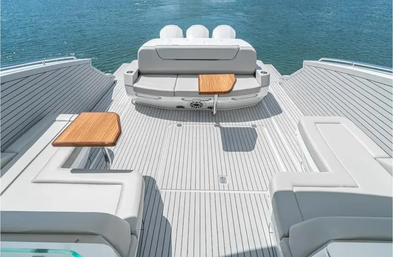 Slide: The Image of Luxurious 2025 Cruisers Yachts 50 GLS deck with seating and tables on open water. - 17