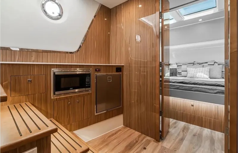 Slide: The Image of Luxurious interior of 2025 Cruisers Yachts 50 GLS with modern kitchen and cozy bedroom. - 32