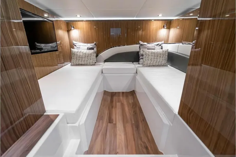Slide: The Image of Luxurious interior of 2025 Cruisers Yachts 50 GLS with modern wood finish and cozy seating. - 44
