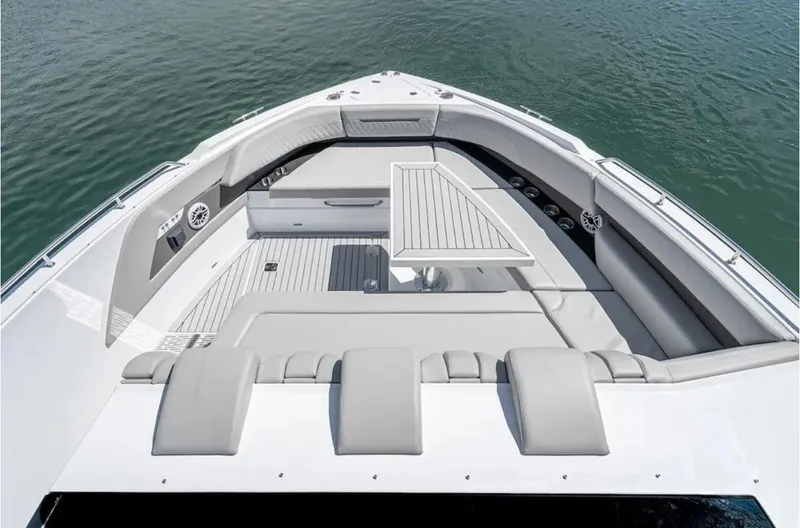 Slide: The Image of 2025 Cruisers Yachts 50 GLS luxury boat interior with seating and table on water. - 47