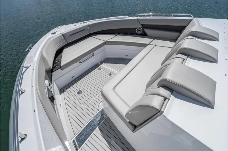 Slide: The Image of 2025 Cruisers Yachts 50 GLS luxury boat seating area on calm water. - 48