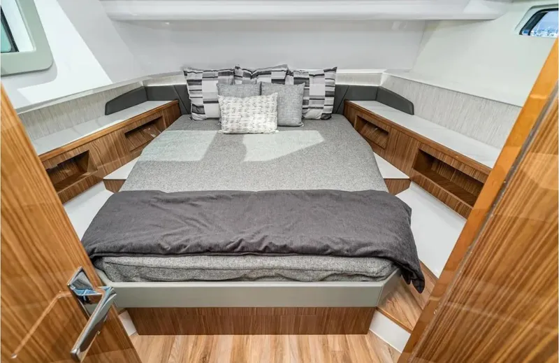 Slide: The Image of Luxurious bedroom interior of 2025 Cruisers Yachts 50 GLS with modern design and cozy bedding. - 33