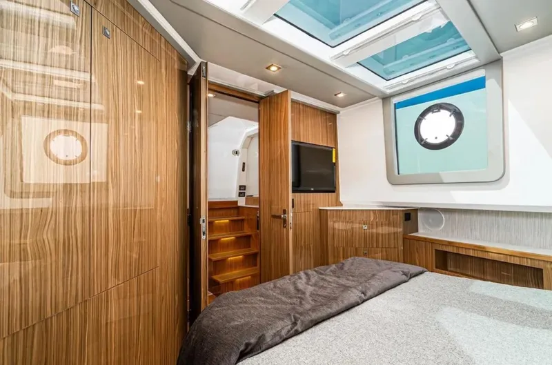 Slide: The Image of Luxurious cabin interior of 2025 Cruisers Yachts 50 GLS with skylights and wood paneling. - 34