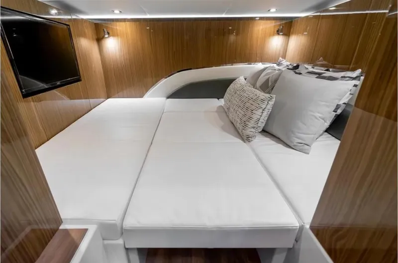 Slide: The Image of Luxurious cabin interior of 2025 Cruisers Yachts 50 GLS with modern wood paneling. - 43