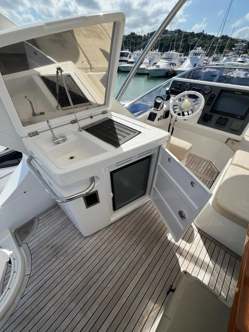 Slide: The Image of 2016 Azimut 54fly yacht cockpit with open kitchenette and steering area. - 12