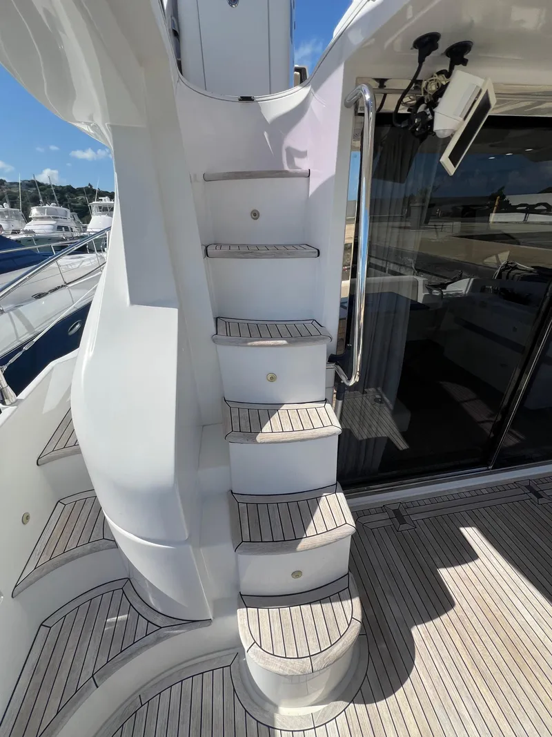 Slide: The Image of Staircase on 2016 Azimut 54fly yacht, featuring sleek design and wooden steps. - 18