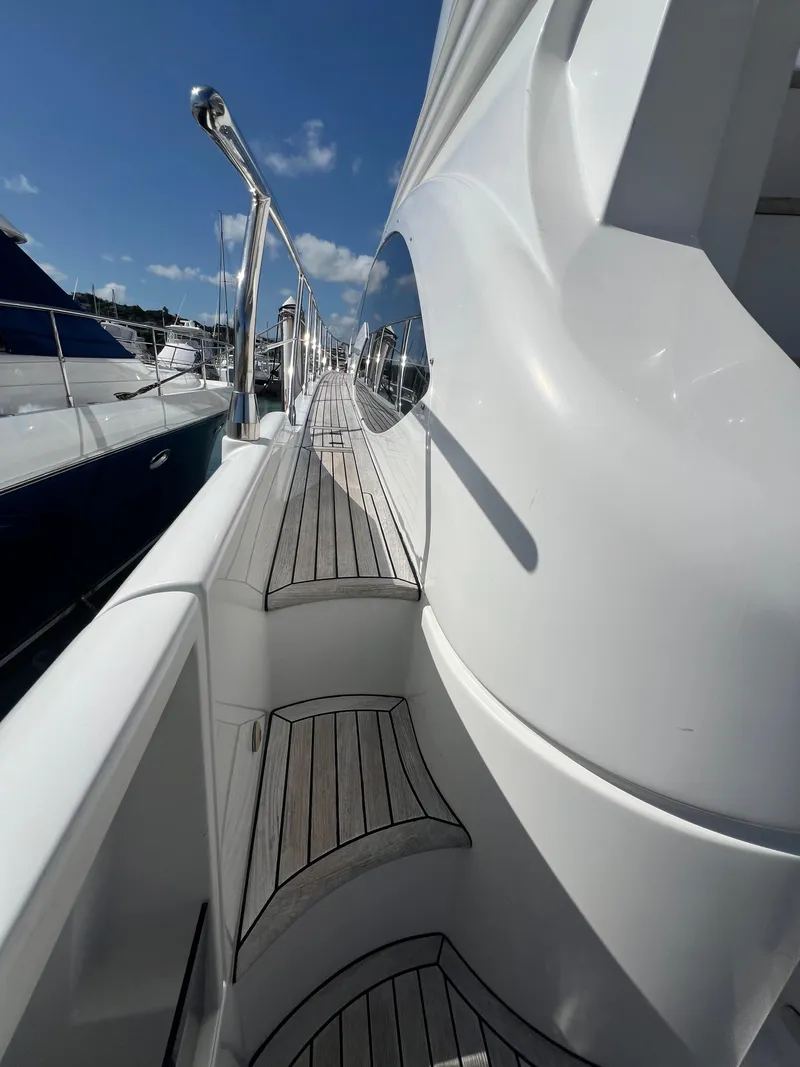 Slide: The Image of Azimut 54fly 2016 yacht deck with sleek design and wooden flooring. - 19