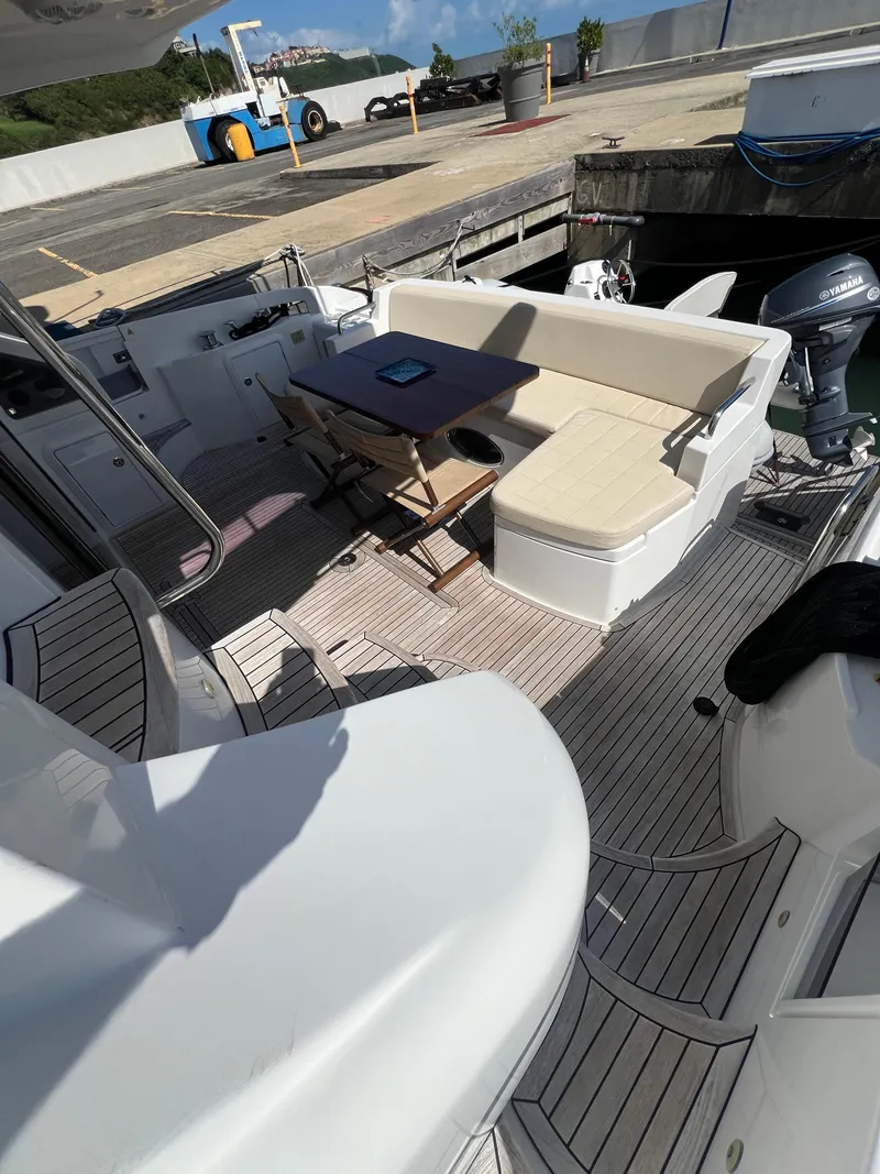 Slide: The Image of 2016 Azimut 54fly yacht deck with seating and table, docked at marina. - 21