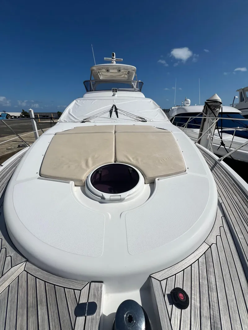 Slide: The Image of 2016 Azimut 54fly yacht with sunbathing deck, docked under clear blue sky. - 26
