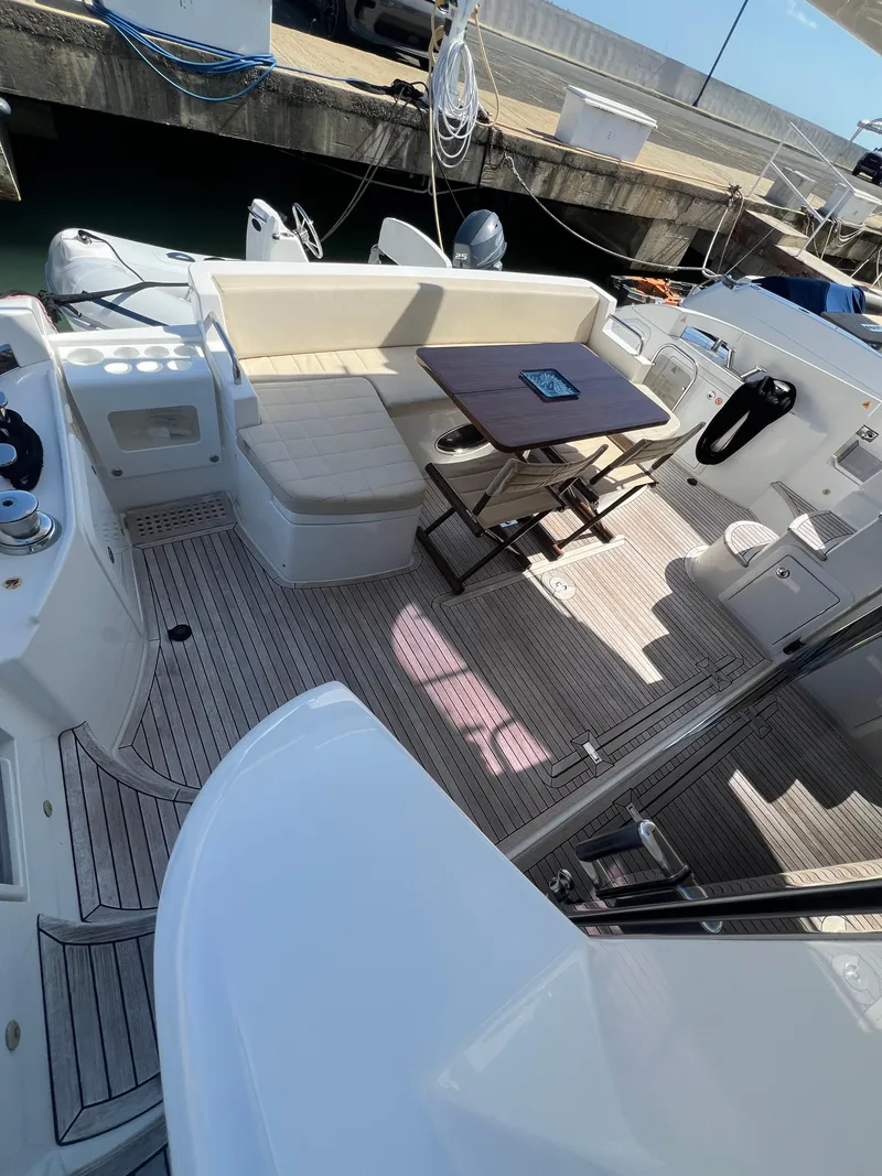 Slide: The Image of 2016 Azimut 54fly yacht deck with seating and table, docked at marina. - 27
