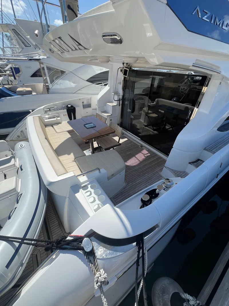 Slide: The Image of Azimut 54fly 2016 yacht with spacious deck and seating area in marina. - 29