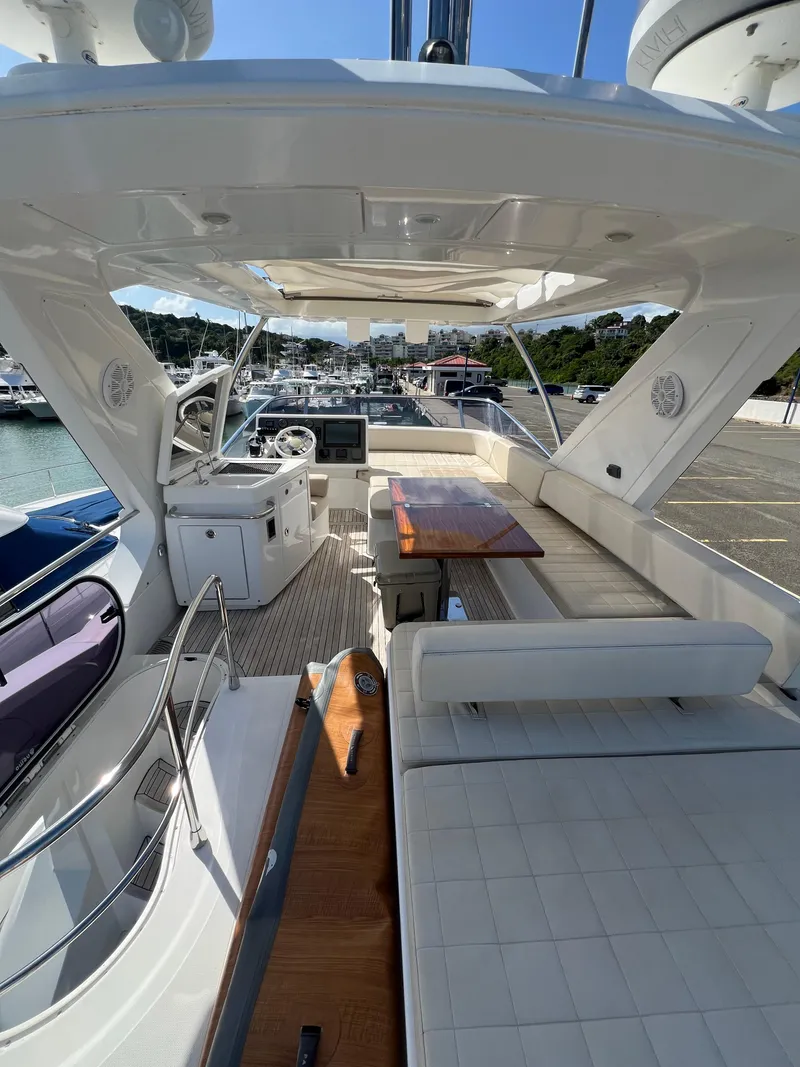 Slide: The Image of 2016 Azimut 54fly yacht interior with seating and helm, docked at marina. - 7