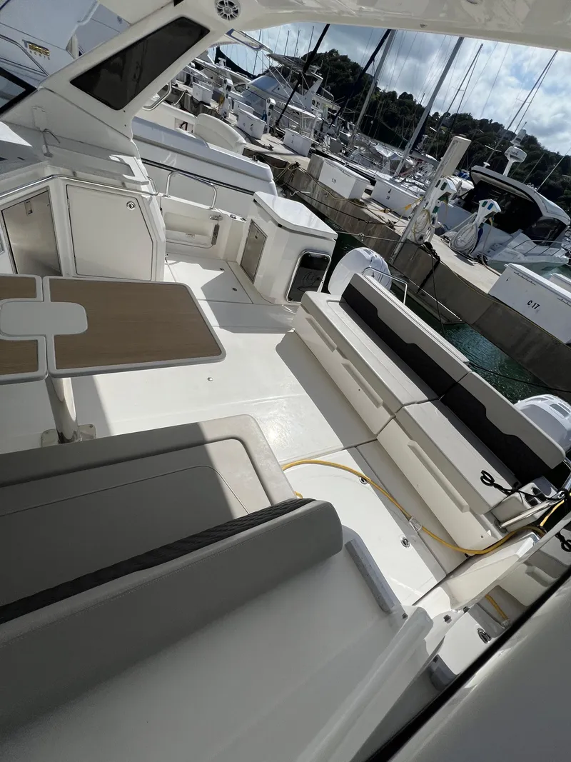 Slide: The Image of 2023 Aquila 36 Sport yacht interior with seating and table, docked at marina. - 17
