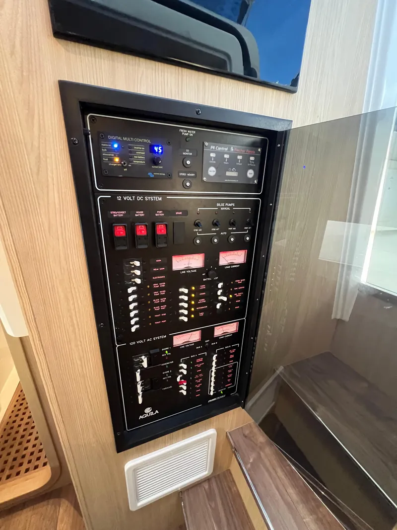 Slide: The Image of Electrical control panel in 2023 Aquila 36 Sport boat interior. - 21