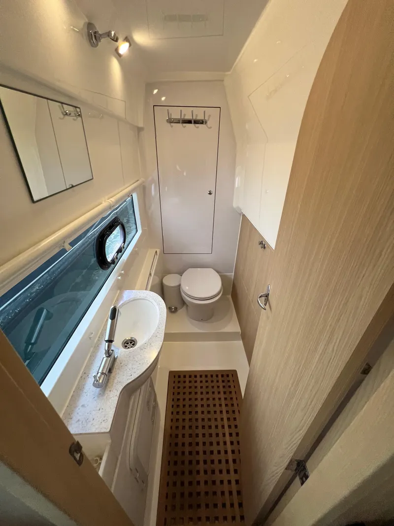 Slide: The Image of 2023 Aquila 36 Sport yacht bathroom with sink, toilet, and window. - 22