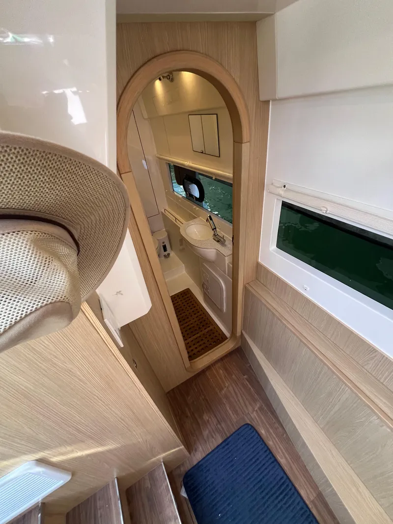 Slide: The Image of Interior of 2023 Aquila 36 Sport yacht, featuring modern bathroom and wooden accents. - 25