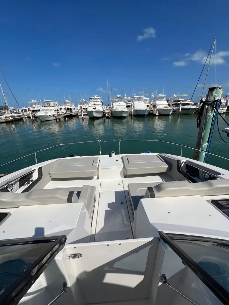 Slide: The Image of 2023 Aquila 36 Sport yacht docked in a marina under clear blue skies. - 28