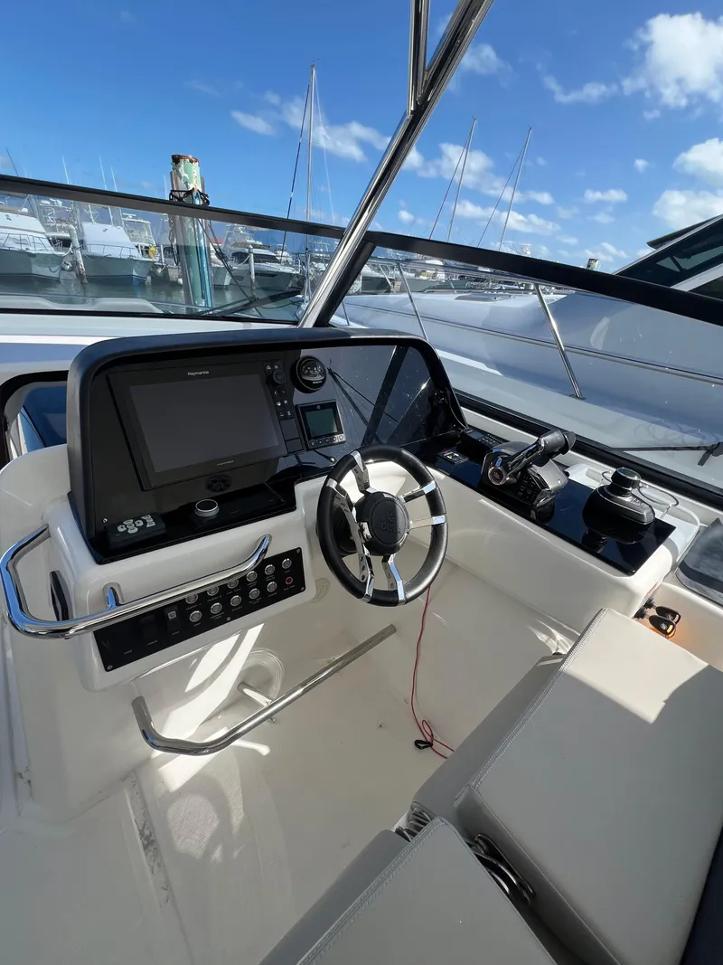 Slide: The Image of 2023 Aquila 36 Sport boat helm with modern controls and navigation system. - 30