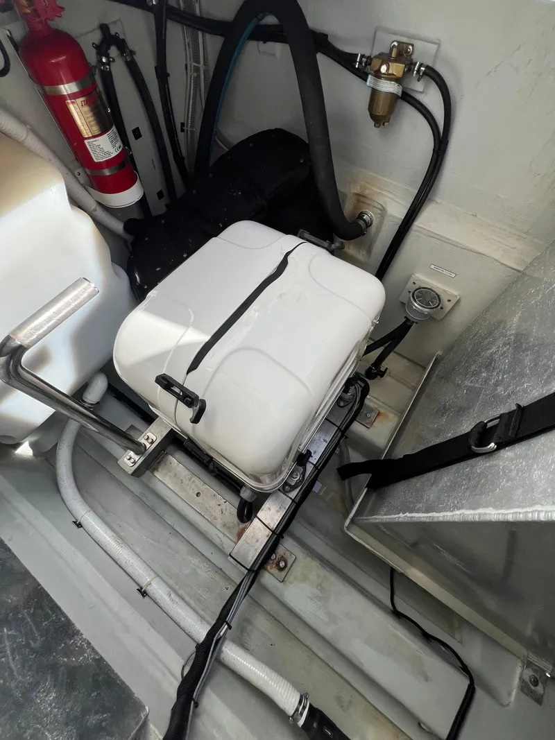 Slide: The Image of Engine compartment of 2023 Aquila 36 Sport, featuring equipment and safety gear. - 32