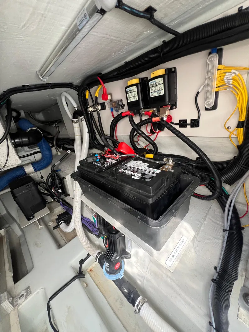 Slide: The Image of 2023 Aquila 36 Sport engine compartment with battery and wiring. - 33