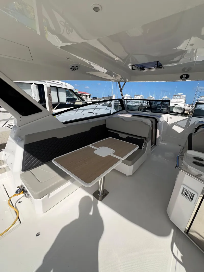 Slide: The Image of 2023 Aquila 36 Sport yacht interior with seating and table, docked at marina. - 34