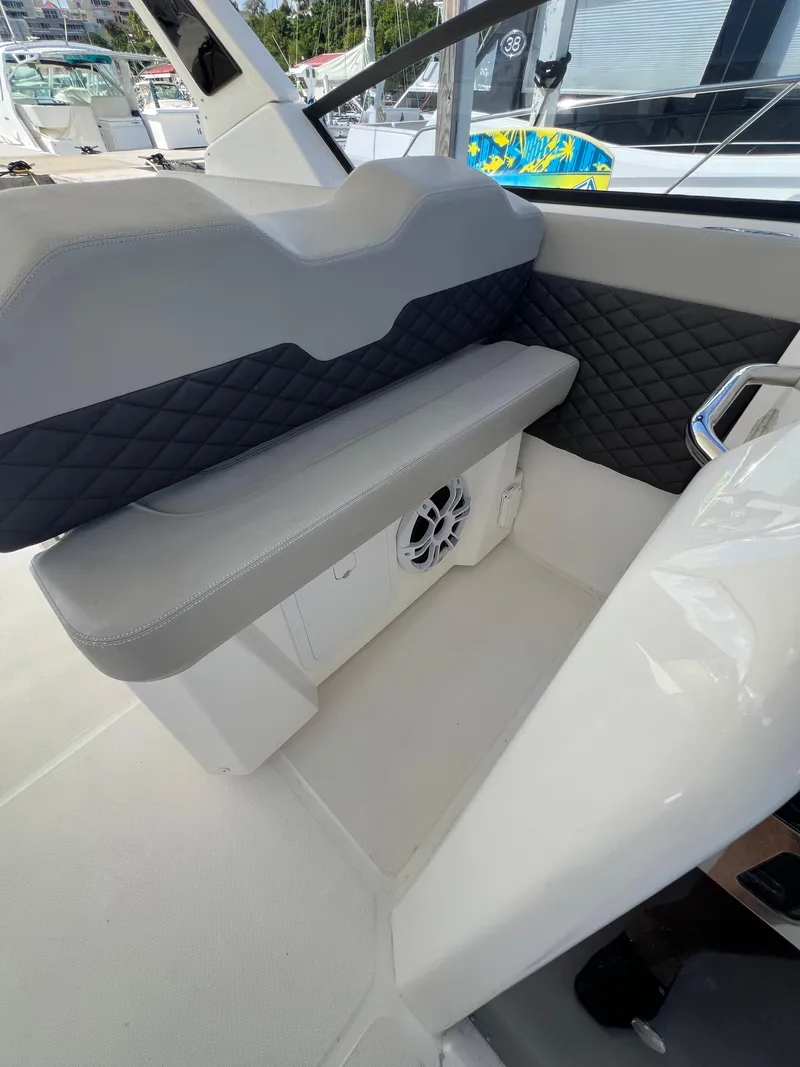 Slide: The Image of 2023 Aquila 36 Sport boat interior with gray seating and speaker. - 36