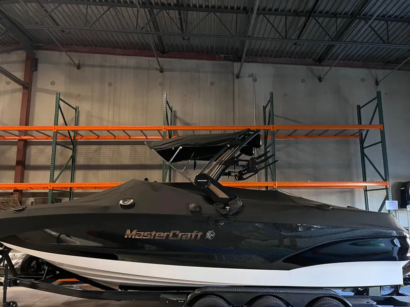 Slide: The Image of 2022 MasterCraft X24 boat in storage, covered and on a trailer. - 1