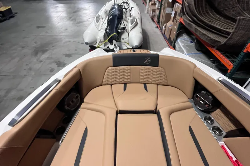 Slide: The Image of 2022 MasterCraft X24 boat interior with tan seating and modern design. - 10