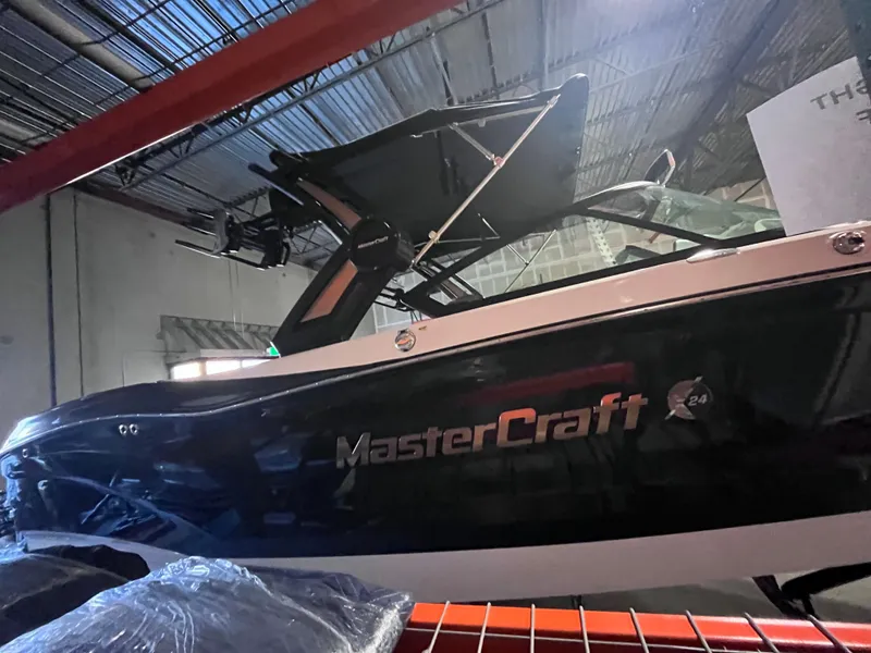 Slide: The Image of 2022 MasterCraft X24 boat in warehouse, side view. - 2