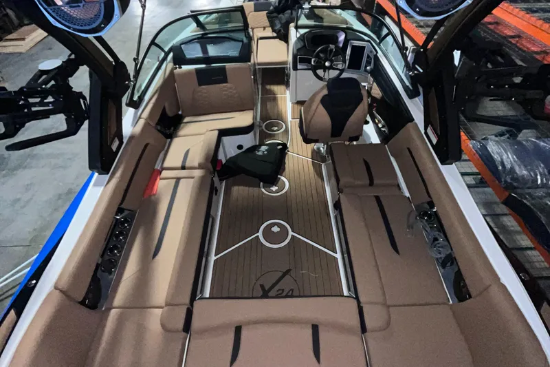 Slide: The Image of 2022 MasterCraft X24 boat interior with tan seating and sleek design. - 4