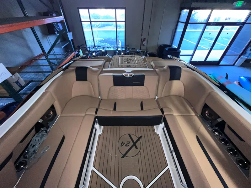 Slide: The Image of 2022 MasterCraft X24 boat interior with tan seating and sleek design. - 5