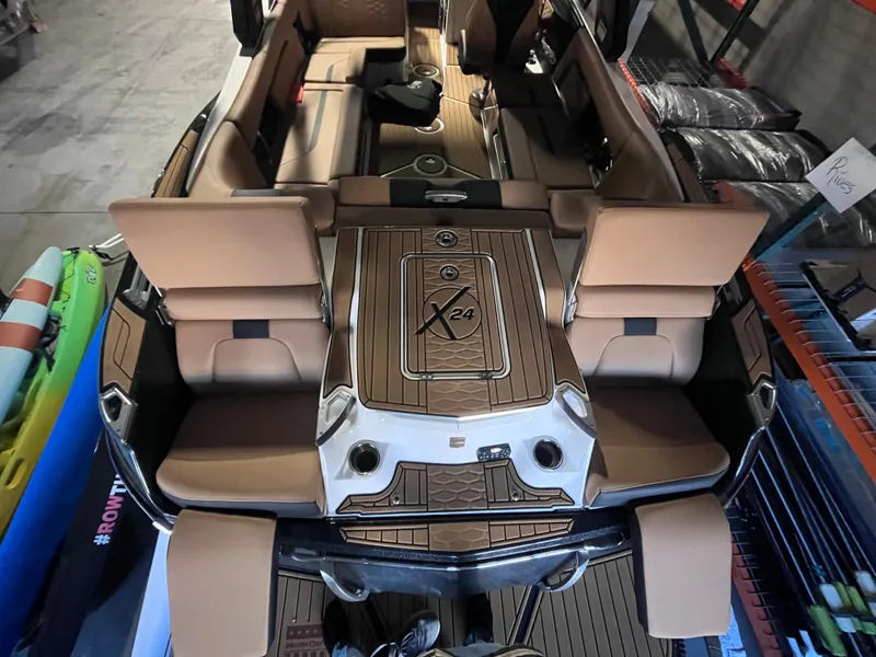 Slide: The Image of 2022 MasterCraft X24 boat interior with tan seating and sleek design. - 6