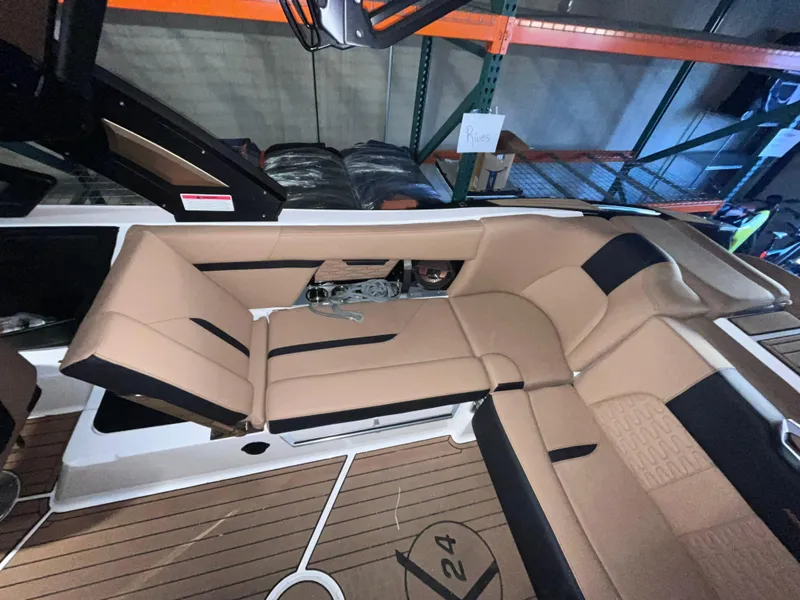 Slide: The Image of 2022 MasterCraft X24 boat interior with tan and black seating. - 7