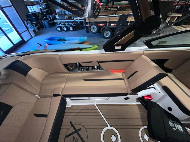 Slide: The Image of 2022 MasterCraft X24 boat interior with tan seating and modern design. - 8