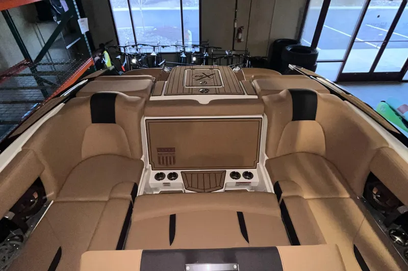 Slide: The Image of 2022 MasterCraft X24 boat interior with tan seating and modern design. - 9