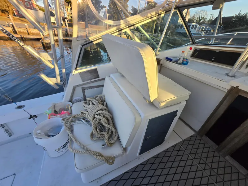 Slide: The Image of 1984 Topaz 36 Sportfisherman boat interior with seating, rope, and fishing gear. - 10