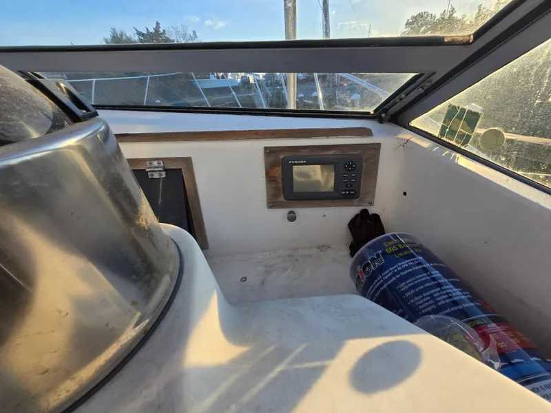Slide: The Image of 1984 Topaz 36 Sportfisherman cockpit with navigation equipment and storage area. - 15