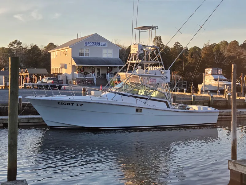 Slide: The Image of 1984 Topaz 36 Sportfisherman docked at marina, with "Eight Up" on the side. - 23