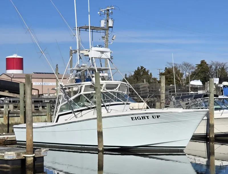 Slide: The Image of 1984 Topaz 36 Sportfisherman boat docked at marina, named "Eight Up". - 25
